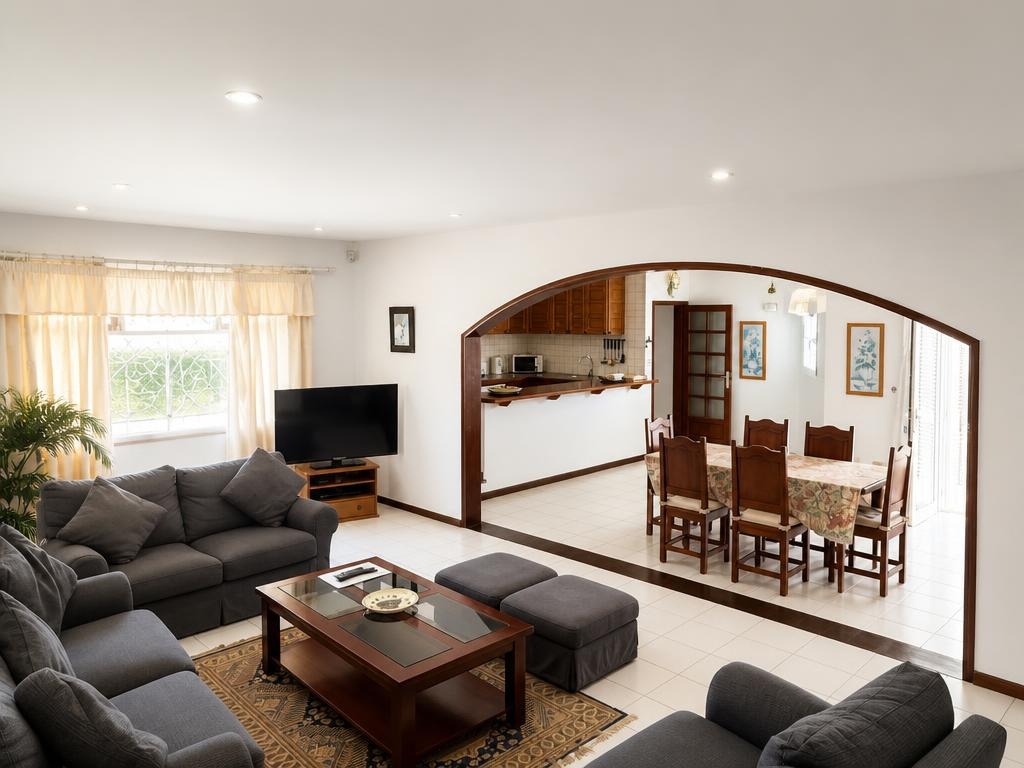 Living room with arch to dining area